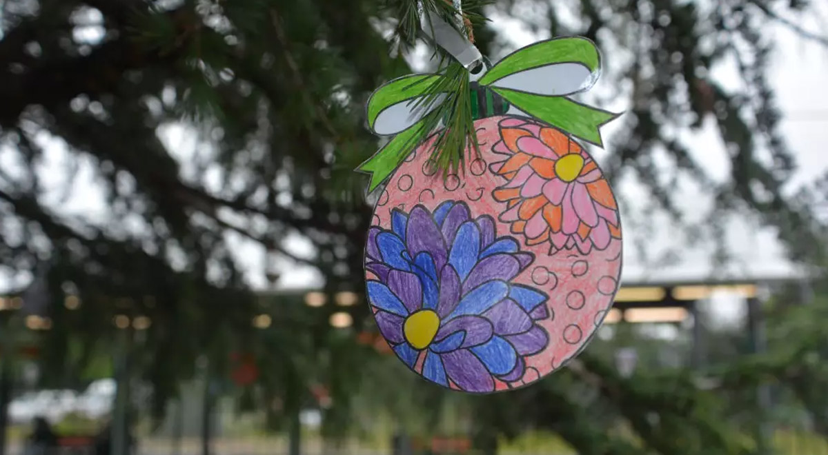 A close-up showing one of the student-made decorations attached to the tree in Manners Park each year