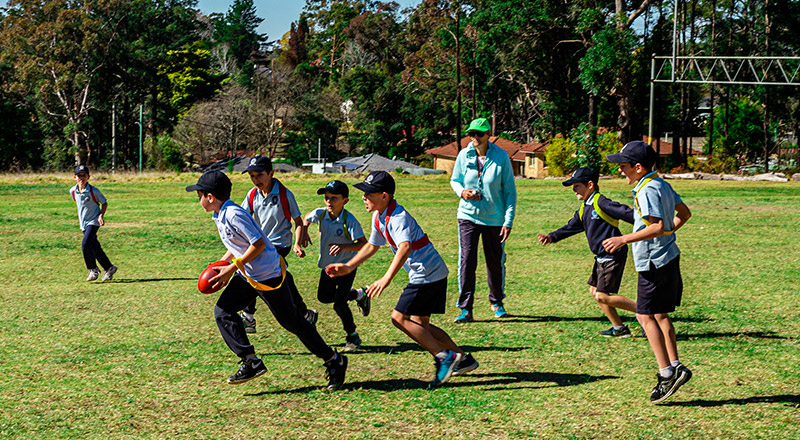 Students playing AFL at St Thomas Aquinas Catholic Primary Springwood