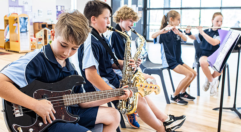 St Thomas Aquinas Catholic Primary Springwood student playing bass guitar