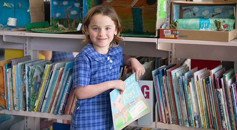 Student borrowing books from the St Thomas Aquinas Catholic Primary Springwood School Library