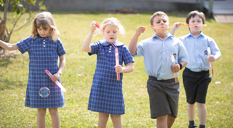 St Thomas Aquinas Catholic Primary School students blowing bubbles