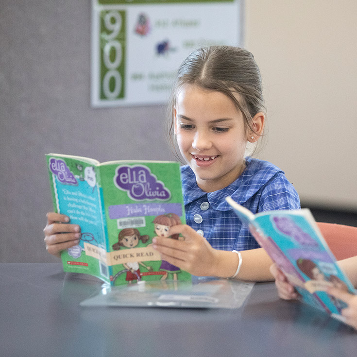 Students reading in the school library at Thomas Aquinas Catholic Primary Springwood