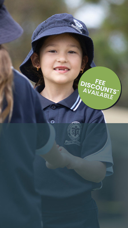 Happy Stage 1 student outdoors at St Thomas Aquinas, Springwood